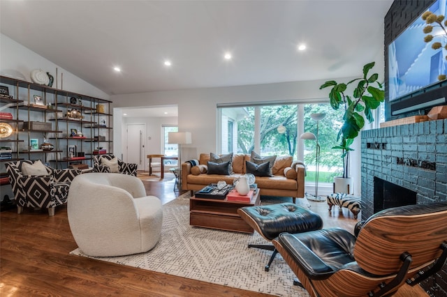 2811 Maple Springs Blvd, Dallas, TX 75235 - living room featuring vaulted ceiling, wood finished floors, recessed lighting, and a brick fireplace
