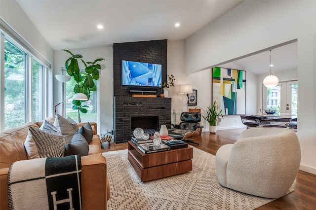 2811 Maple Springs Blvd, Dallas, TX 75235 - living room featuring lofted ceiling, plenty of natural light, wood finished floors, a brick fireplace, and recessed lighting