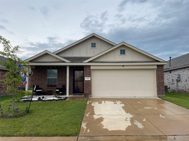 803 Odlozil Ln, Ennis, TX 75119 - view of front of house with board and batten siding, brick siding, driveway, and a front yard