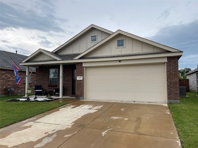 803 Odlozil Ln, Ennis, TX 75119 - view of front of home with brick siding, board and batten siding, covered porch, concrete driveway, and a front yard