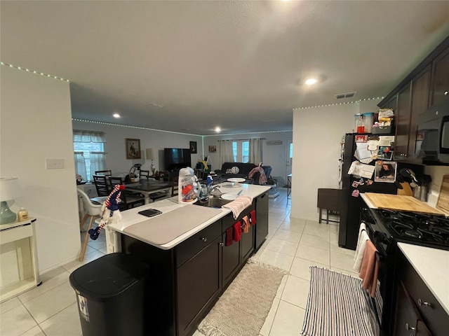 803 Odlozil Ln, Ennis, TX 75119 - kitchen with black gas stove, light countertops, light tile patterned flooring, a center island, and recessed lighting