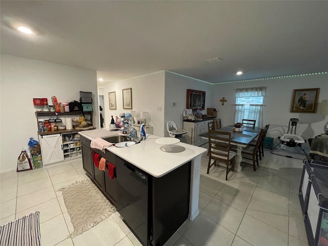 803 Odlozil Ln, Ennis, TX 75119 - kitchen featuring black dishwasher, a center island with sink, light tile patterned floors, recessed lighting, and light countertops
