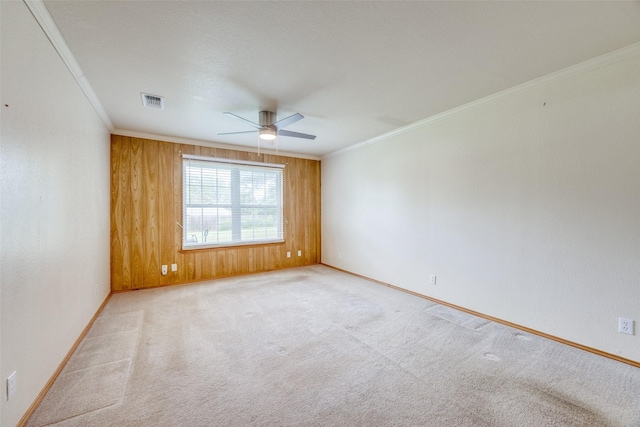 15 Cumberland Cir, Denison, TX 75021 - spare room featuring ceiling fan, crown molding, light colored carpet, and wood walls