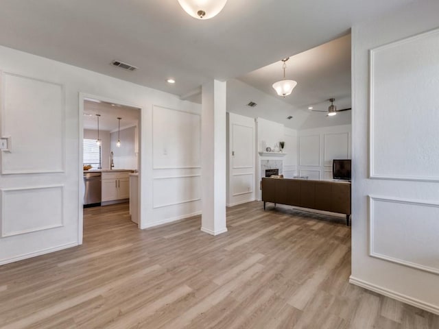 2614 San Saba St, Mesquite, TX 75150 - unfurnished bedroom with light wood-style flooring, a fireplace, vaulted ceiling, ensuite bathroom, and recessed lighting
