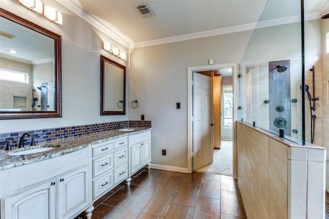 6707 Canyon Crest Dr, Fort Worth, TX 76132 - bathroom featuring double vanity, a walk in shower, healthy amount of natural light, crown molding, and decorative backsplash