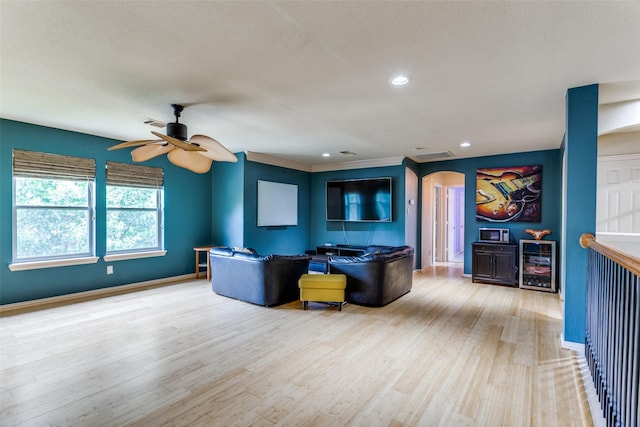 6707 Canyon Crest Dr, Fort Worth, TX 76132 - living area with arched walkways, ceiling fan, wood finished floors, recessed lighting, and beverage cooler