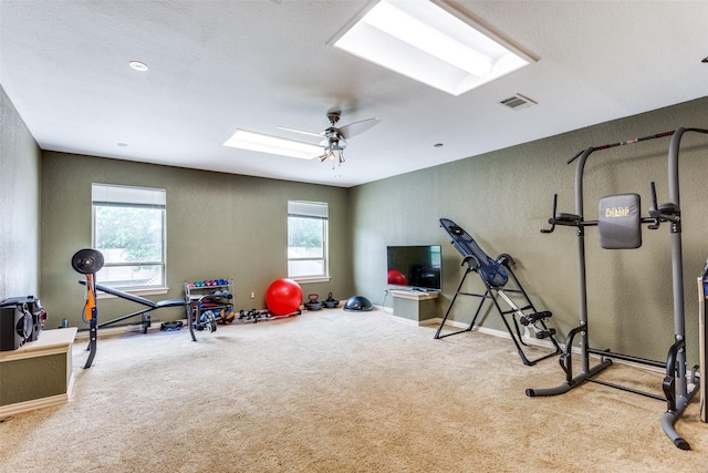 6707 Canyon Crest Dr, Fort Worth, TX 76132 - workout area with a textured wall, plenty of natural light, carpet floors, a skylight, and a ceiling fan
