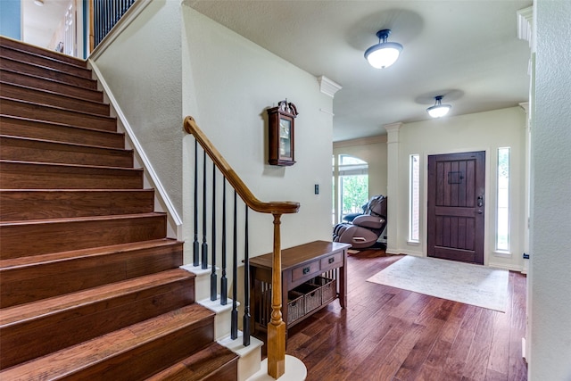 6707 Canyon Crest Dr, Fort Worth, TX 76132 - entryway with dark wood finished floors, stairway, a textured wall, and decorative columns