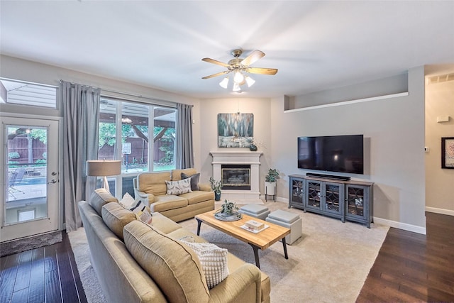 5513 Hill Haven Ct, Frisco, TX 75035 - living room with wood finished floors, a ceiling fan, and a glass covered fireplace