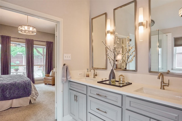 5513 Hill Haven Ct, Frisco, TX 75035 - ensuite bathroom featuring double vanity and a chandelier