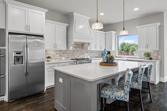 309 Red River Cir Trail, Highland Village, TX 75077 - kitchen with stainless steel appliances, tasteful backsplash, dark wood finished floors, white cabinets, and recessed lighting