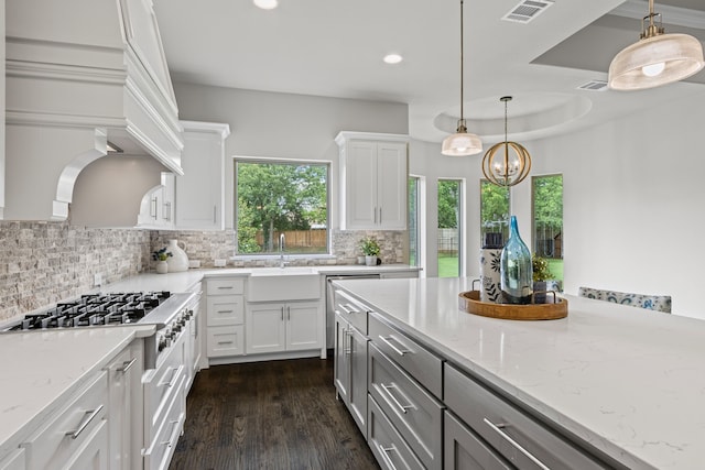 309 Red River Cir Trail, Highland Village, TX 75077 - kitchen with stainless steel gas stovetop, decorative backsplash, light stone countertops, white cabinetry, and recessed lighting