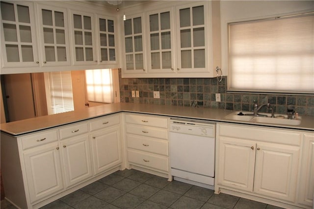 1612 Canyon Oaks Dr, Irving, TX 75061 - kitchen with dishwasher, dark tile patterned flooring, glass insert cabinets, white cabinets, and decorative backsplash