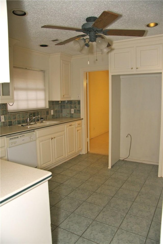 1612 Canyon Oaks Dr, Irving, TX 75061 - kitchen with white dishwasher, tasteful backsplash, ceiling fan, a textured ceiling, and white cabinets