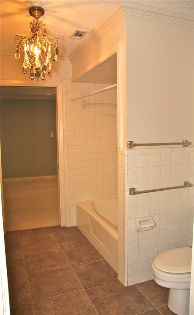 1612 Canyon Oaks Dr, Irving, TX 75061 - full bathroom featuring tile patterned floors, ornamental molding, a chandelier, tub / shower combination, and tile walls