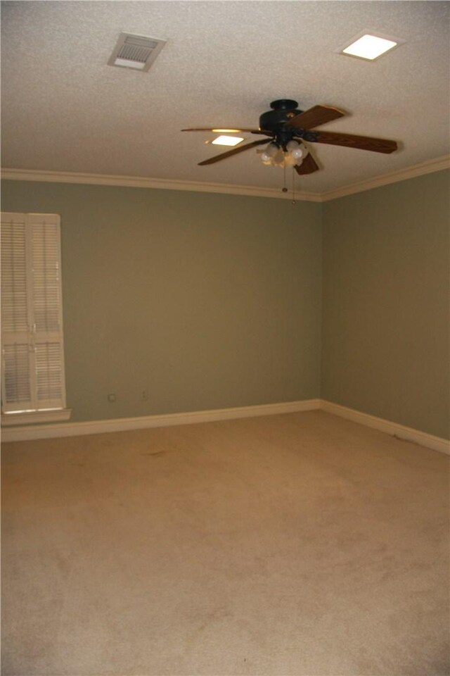 1612 Canyon Oaks Dr, Irving, TX 75061 - carpeted spare room with ceiling fan, ornamental molding, and a textured ceiling