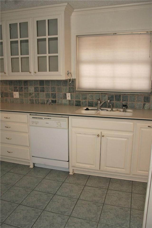 1612 Canyon Oaks Dr, Irving, TX 75061 - kitchen featuring white dishwasher, dark tile patterned flooring, tasteful backsplash, white cabinetry, and glass insert cabinets