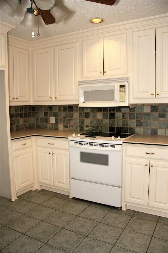 1612 Canyon Oaks Dr, Irving, TX 75061 - kitchen with white appliances, dark tile patterned floors, decorative backsplash, and ceiling fan