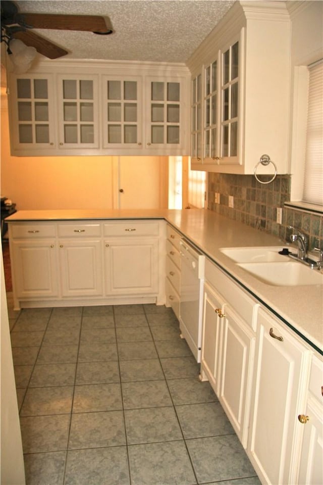 1612 Canyon Oaks Dr, Irving, TX 75061 - kitchen featuring dishwasher, ceiling fan, tile patterned flooring, white cabinets, and light countertops