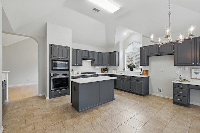 2402 Pittsburg Lndg, Mesquite, TX 75181 - kitchen with appliances with stainless steel finishes, a center island, light countertops, a chandelier, and high vaulted ceiling
