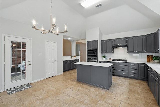 2402 Pittsburg Lndg, Mesquite, TX 75181 - kitchen with black microwave, oven, arched walkways, gas stovetop, and high vaulted ceiling