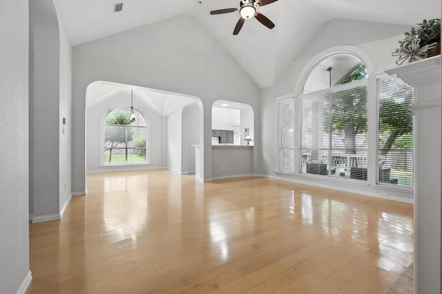 2402 Pittsburg Lndg, Mesquite, TX 75181 - unfurnished living room with arched walkways, ceiling fan, lofted ceiling, and wood finished floors