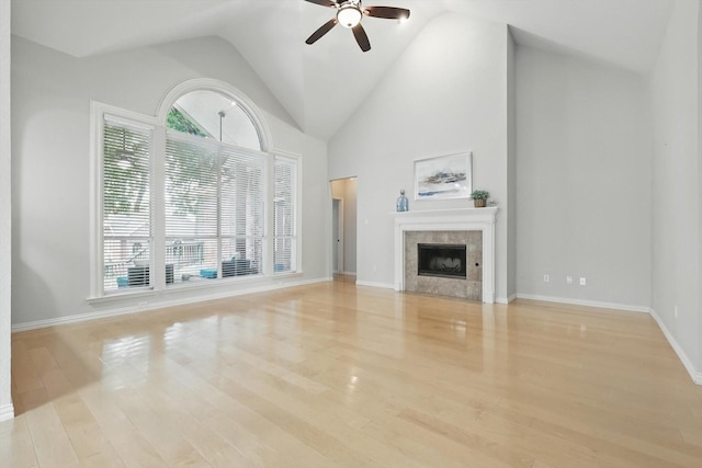 2402 Pittsburg Lndg, Mesquite, TX 75181 - unfurnished living room with a ceiling fan, a tile fireplace, wood finished floors, and high vaulted ceiling