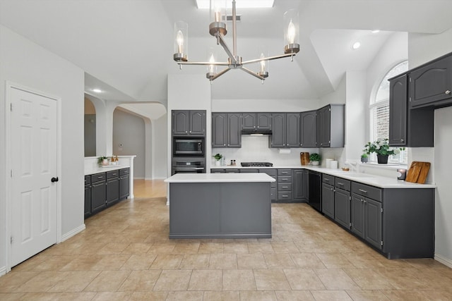 2402 Pittsburg Lndg, Mesquite, TX 75181 - kitchen with black appliances, gray cabinetry, a chandelier, arched walkways, and a center island