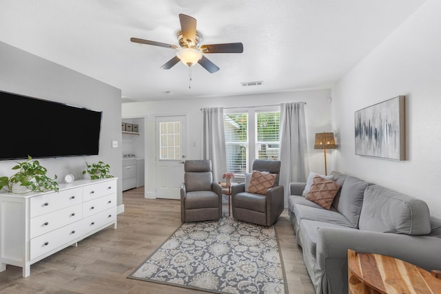 10917 Caldwell Ln, Fort Worth, TX 76179 - living area with separate washer and dryer, a ceiling fan, and light wood-style flooring
