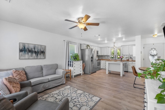 10917 Caldwell Ln, Fort Worth, TX 76179 - living area featuring a ceiling fan and light wood finished floors