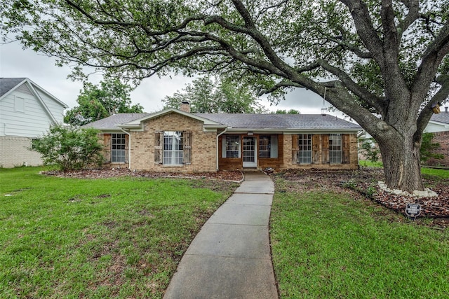 1614 Baltimore Dr, Richardson, TX 75081 - ranch-style house featuring brick siding, a chimney, a front yard, and a shingled roof