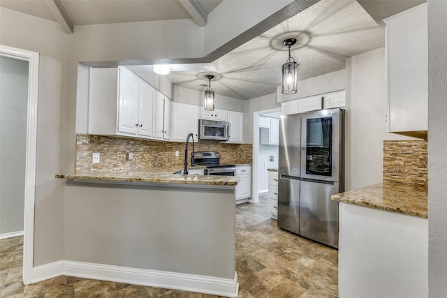 1614 Baltimore Dr, Richardson, TX 75081 - kitchen featuring appliances with stainless steel finishes, decorative backsplash, light stone countertops, white cabinets, and a peninsula