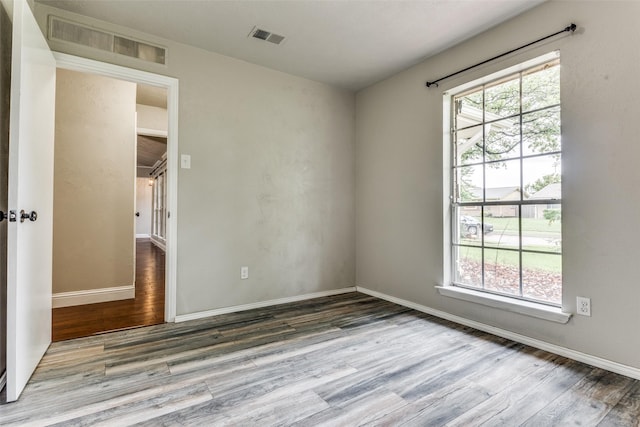 1614 Baltimore Dr, Richardson, TX 75081 - empty room with wood finished floors and baseboards