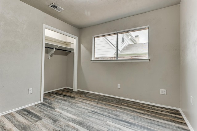 1614 Baltimore Dr, Richardson, TX 75081 - unfurnished bedroom featuring wood finished floors and a closet
