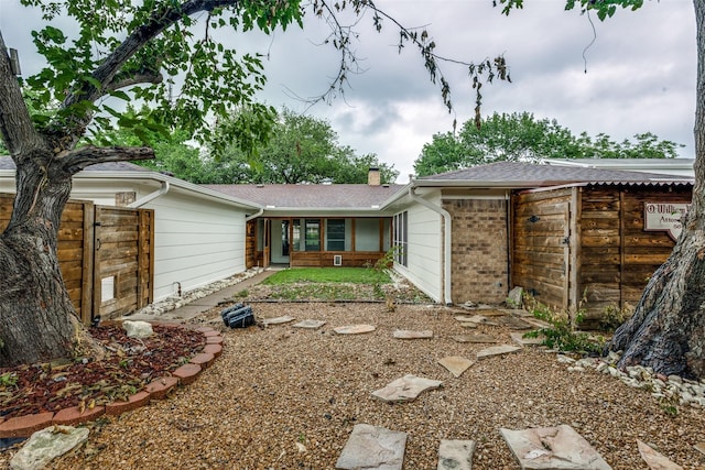 1614 Baltimore Dr, Richardson, TX 75081 - back of property featuring a chimney and brick siding