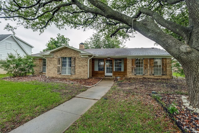 1614 Baltimore Dr, Richardson, TX 75081 - single story home featuring a chimney, brick siding, a front lawn, covered porch, and a shingled roof