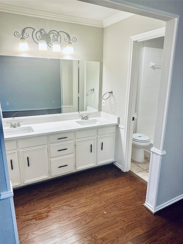5722 Sagebrush Trl, Arlington, TX 76017 - bathroom featuring ornamental molding, wood finished floors, double vanity, and tiled shower