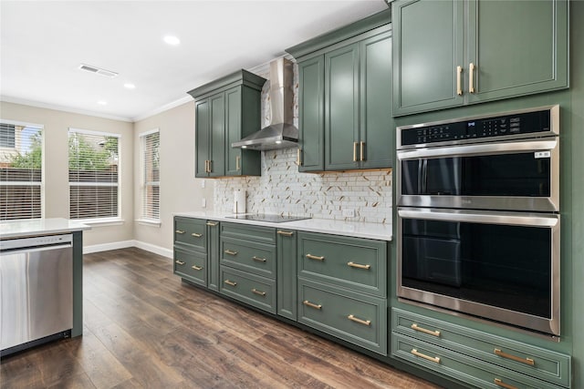 4270 Crooked Stick Dr, Frisco, TX 75035 - kitchen featuring green cabinetry, appliances with stainless steel finishes, wall chimney exhaust hood, ornamental molding, and light countertops