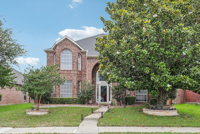 8729 Somerville Way, Plano, TX 75025 - traditional-style house with brick siding, a front yard, and roof with shingles