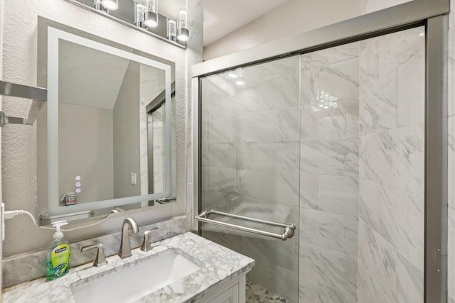 8729 Somerville Way, Plano, TX 75025 - bathroom with vanity, a stall shower, and vaulted ceiling