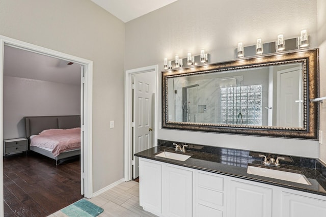 8729 Somerville Way, Plano, TX 75025 - ensuite bathroom with wood finished floors, double vanity, and a walk in shower