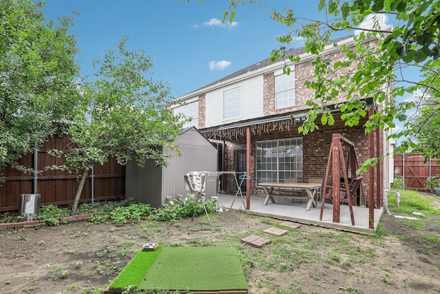 8729 Somerville Way, Plano, TX 75025 - back of house featuring a patio area, brick siding, and a storage shed