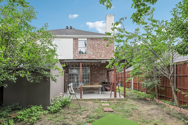 8729 Somerville Way, Plano, TX 75025 - rear view of property featuring a patio, a fenced backyard, brick siding, and a chimney