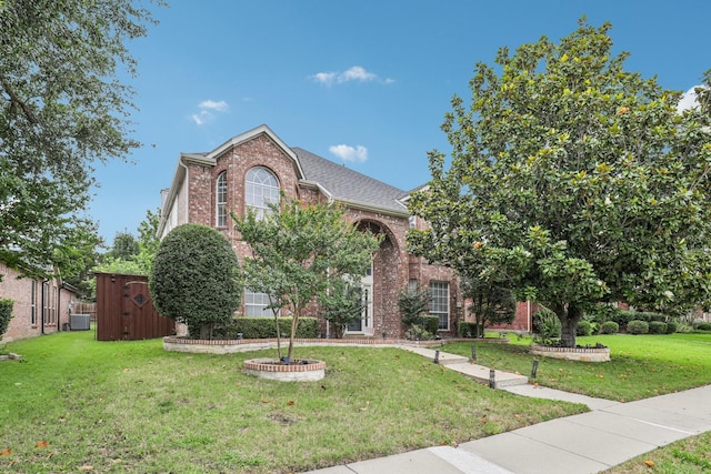 8729 Somerville Way, Plano, TX 75025 - view of front of house featuring brick siding, a front lawn, and roof with shingles