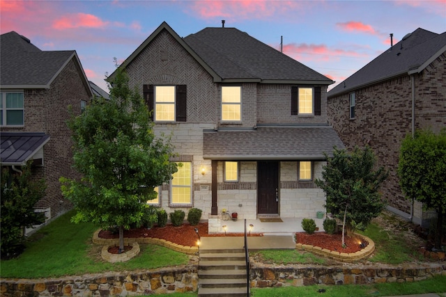334 Pasco Rd, Garland, TX 75044 - view of front of house featuring stone siding, a shingled roof, and brick siding