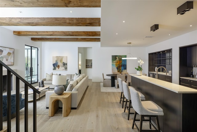 3626 Edgewater St, Dallas, TX 75205 - living room featuring light wood-type flooring, beam ceiling, and stairway