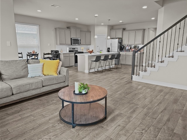 200 Tanager Dr, Rhome, TX 76078 - living area featuring light wood finished floors, recessed lighting, and stairway