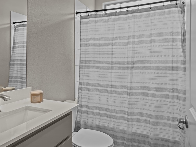 200 Tanager Dr, Rhome, TX 76078 - bathroom featuring a textured wall, vanity, and a shower with shower curtain