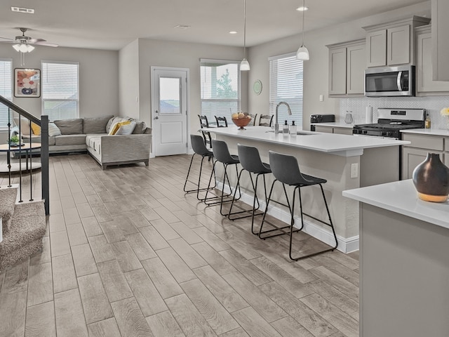 200 Tanager Dr, Rhome, TX 76078 - kitchen with appliances with stainless steel finishes, light countertops, recessed lighting, a kitchen bar, and plenty of natural light