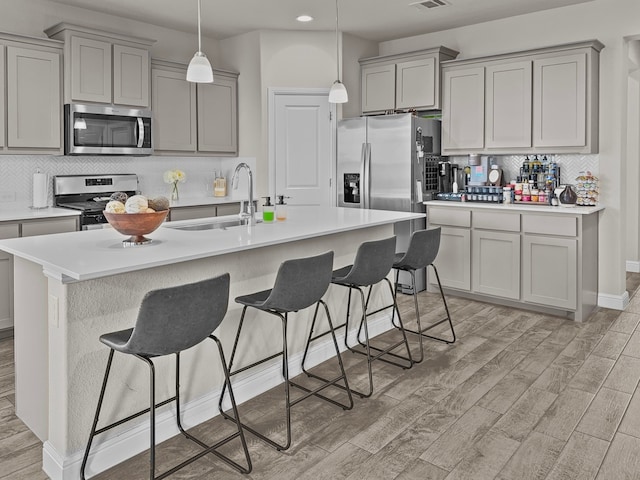 200 Tanager Dr, Rhome, TX 76078 - kitchen with stainless steel appliances, gray cabinets, light wood-type flooring, recessed lighting, and backsplash
